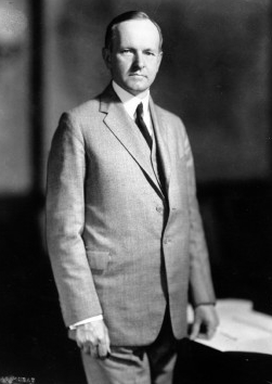 Calvin Coolidge standing the old Cabinet Room of the West Wing. 