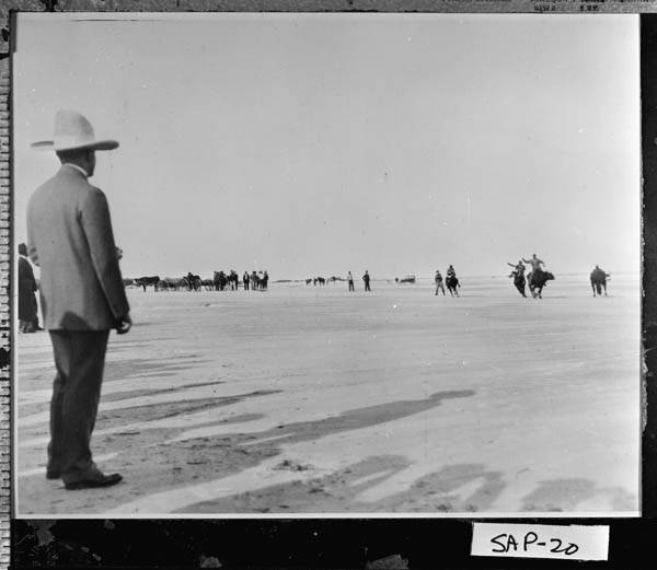 President Coolidge watches the steer riding along the beaches of Sapelo Island, December 1928. 