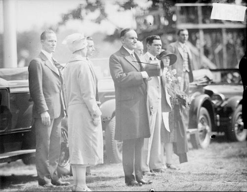 Arriving in Hammond, the Coolidges pause respectfully at Wicker Park