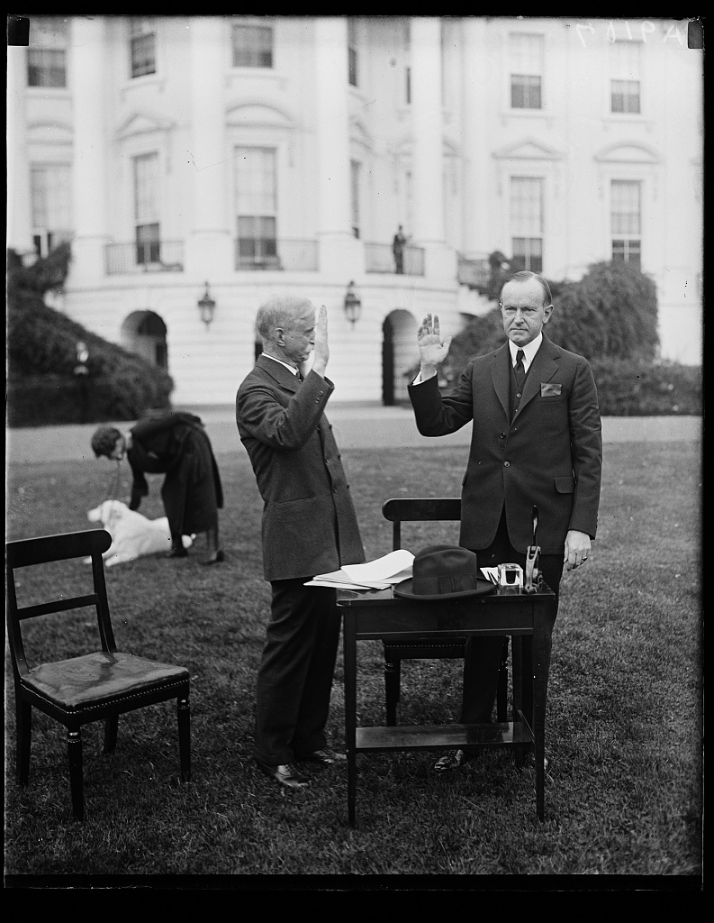 District of Columbia Circuit Judge Josiah A. Van Orsdel, functioning as a polling judge, administers oath to this famous voter, Calvin Coolidge, 1924. The Coolidges would vote by absentee ballot that year since national responsibilities kept them out of their home precinct in Massachusetts. They still made a point of leading by example, however.