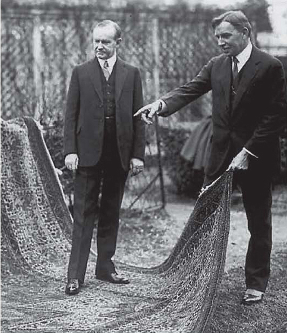 President Coolidge with Dr. Finley as the massive rug is unfurled on the White House lawn. 