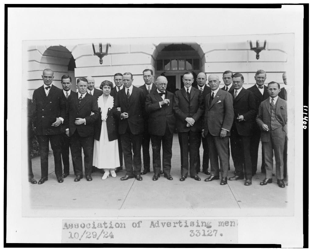 President Coolidge and the First Lady have their picture taken with members of the Advertising Association in 1924, two years before the speech cited below. Courtesy of the Library of Congress.